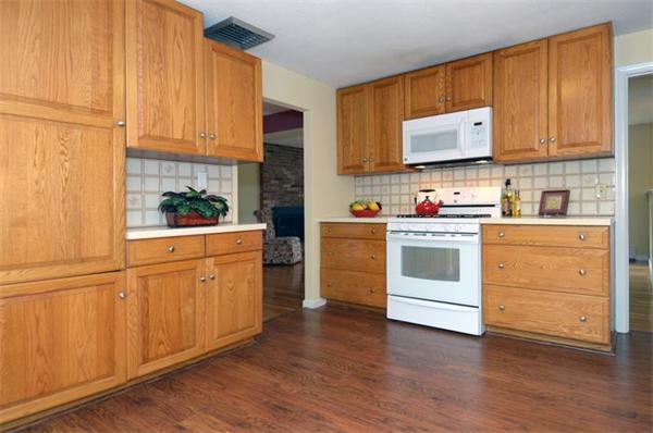 50 Gilbert Road Needham, MA 02492 - Photo 6 of 25 a kitchen with white cabinets sink and white appliances