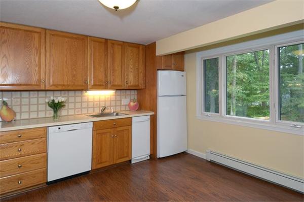 50 Gilbert Road Needham, MA 02492 - Photo 8 of 25 a kitchen with a refrigerator sink and cabinets