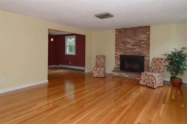 50 Gilbert Road Needham, MA 02492 - Photo 10 of 25 a view of empty room with wooden floor and fireplace