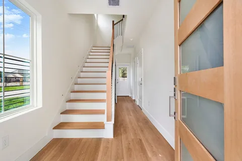 a view of entryway and hall with wooden floor