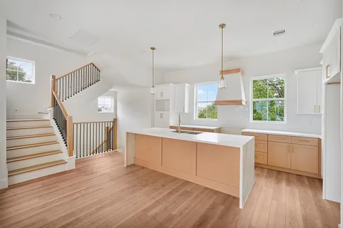 a kitchen with stainless steel appliances granite countertop a stove a sink dishwasher and a wooden cabinets