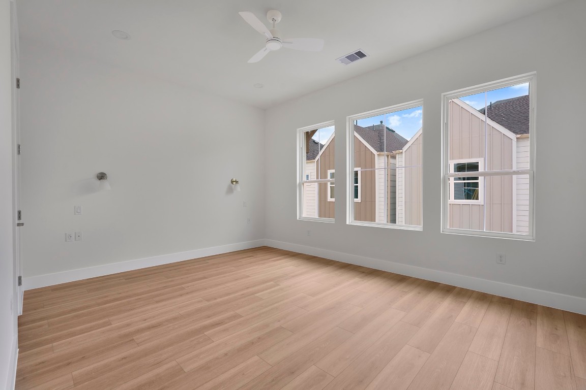 1106 Weiss Street Houston, TX 77009 - Photo 7 of 13 a view of an empty room with wooden floor and a window