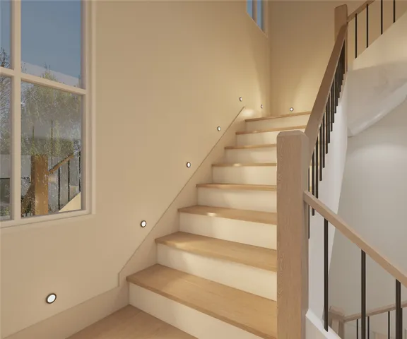 a view of staircase with white walls and windows