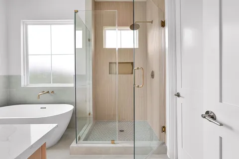 a bathroom with a double vanity sink a toilet and a window
