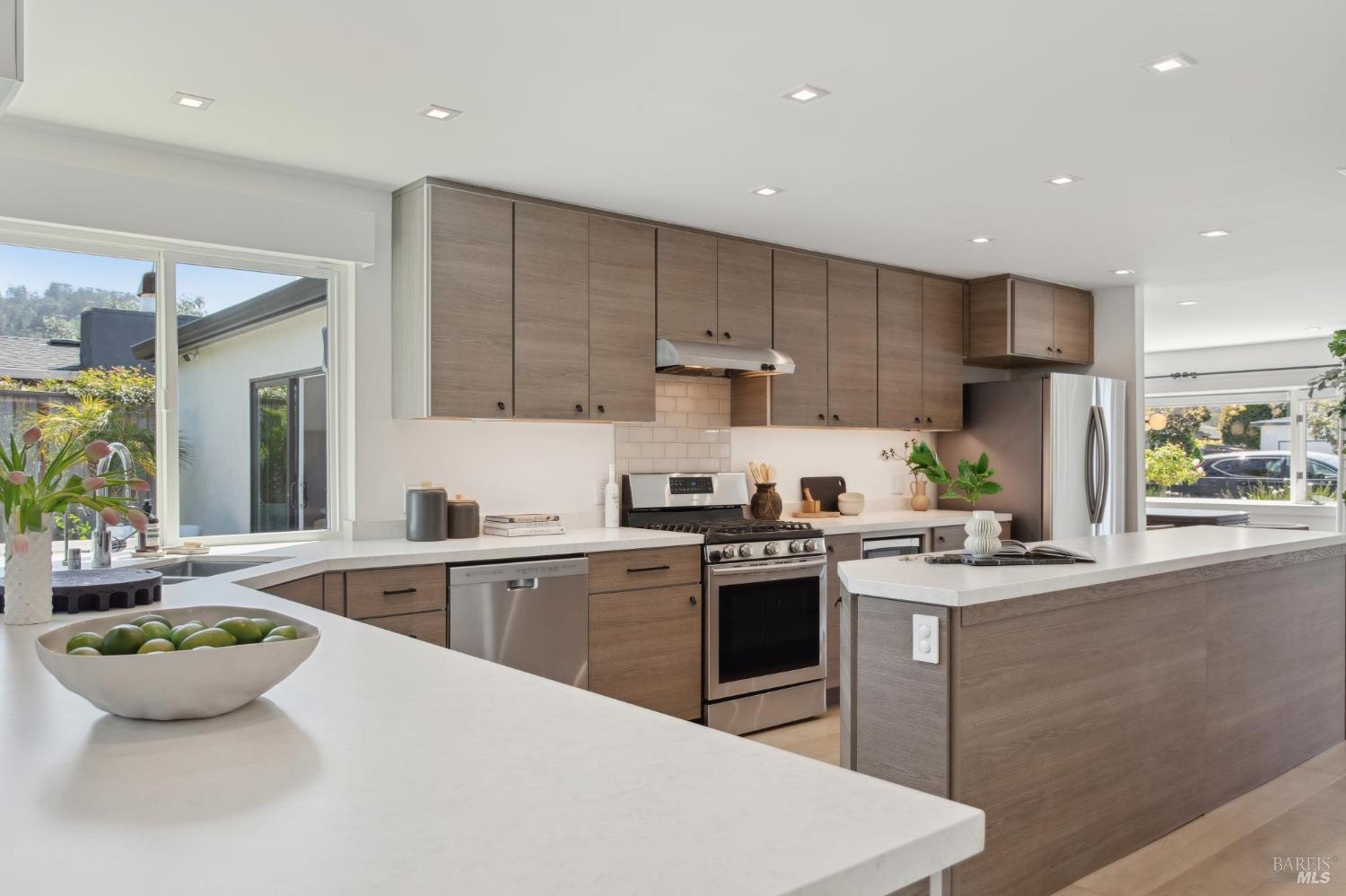 31 Mohawk Avenue Corte Madera, CA 94925 - Photo 11 of 57 a kitchen with kitchen island a stove a sink a refrigerator and cabinets
