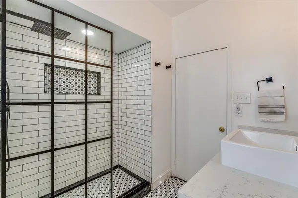 a spacious bedroom with a bed and wooden floor