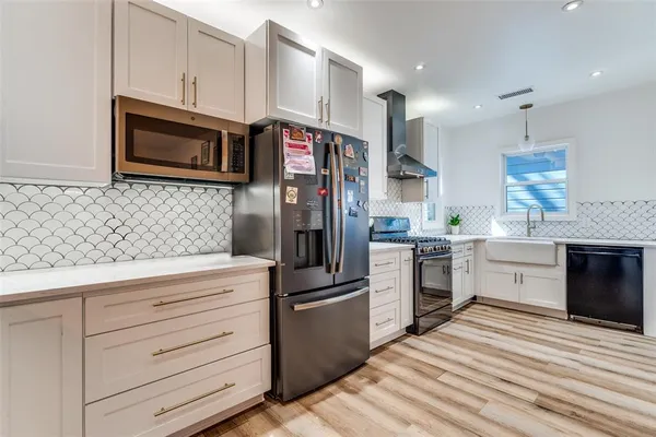 a kitchen with stainless steel appliances granite countertop a stove and a refrigerator