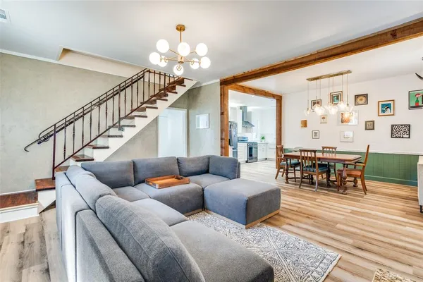 a living room with furniture and a chandelier