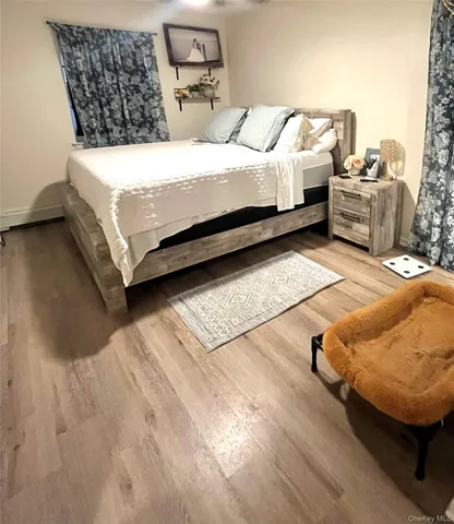 a bed sitting in a bedroom next to a couch