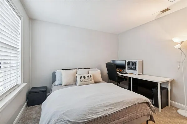 a bedroom with a bed and a television in it