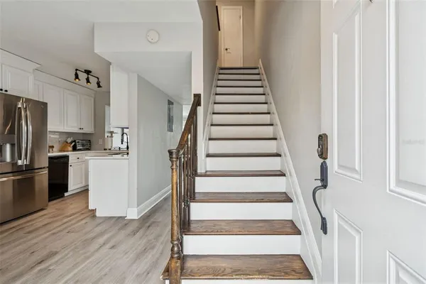 a kitchen with cabinets and wooden floor