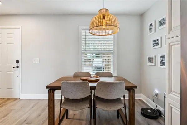 a kitchen with granite countertop a stove a sink and a wooden floor