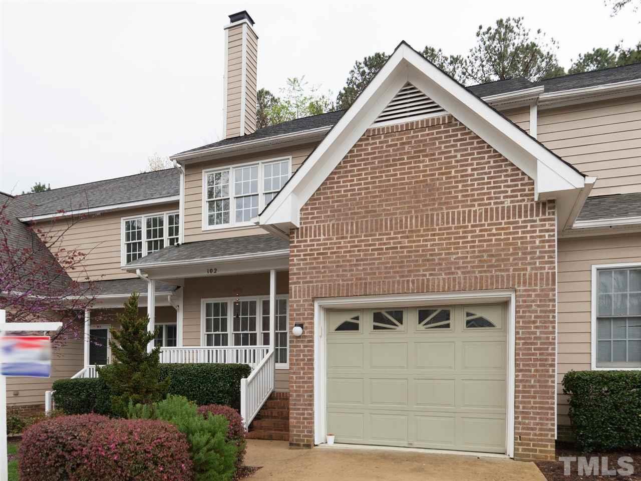 7030 Sandy Forks Road, Unit 102 Raleigh, NC 27615 - Photo 1 of 25 a view of a house with a yard and potted plants