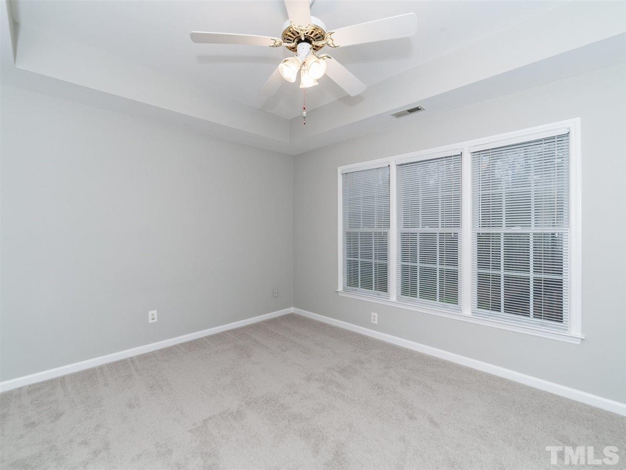 7030 Sandy Forks Road, Unit 102 Raleigh, NC 27615 - Photo 8 of 25 an empty room with a window and a fan