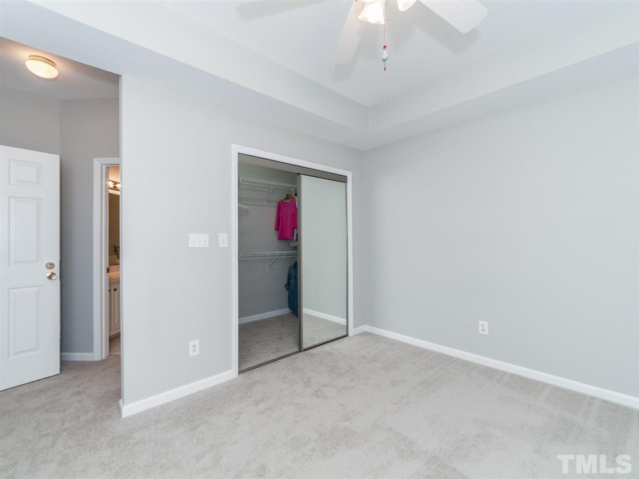 7030 Sandy Forks Road, Unit 102 Raleigh, NC 27615 - Photo 9 of 25 an empty room with a ceiling fan and carpet