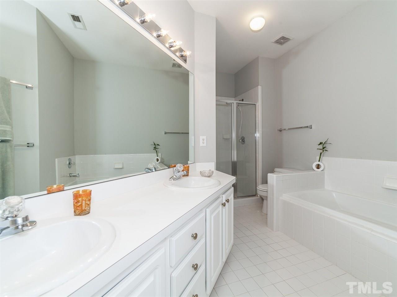 7030 Sandy Forks Road, Unit 102 Raleigh, NC 27615 - Photo 10 of 25 a spacious bathroom with a tub sink and mirror