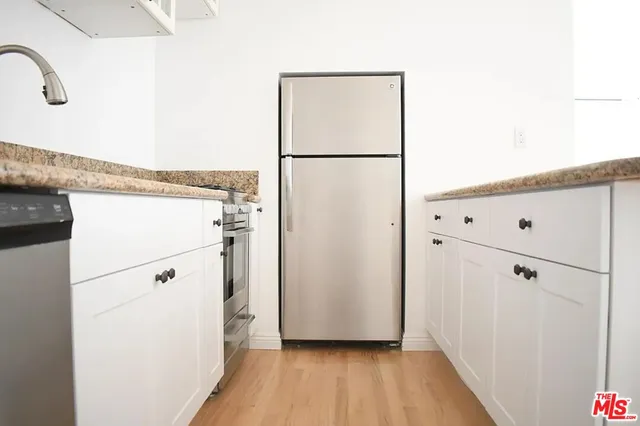 a view of washer and dryer with wooden floor