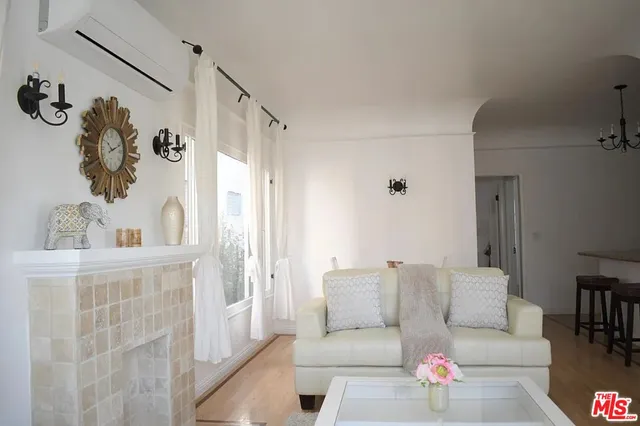 a living room with furniture and a wall painting