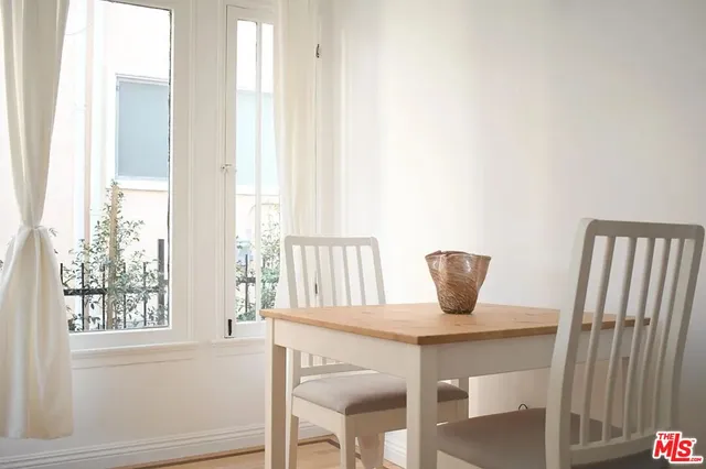 a view of a room that has a window and wooden floor