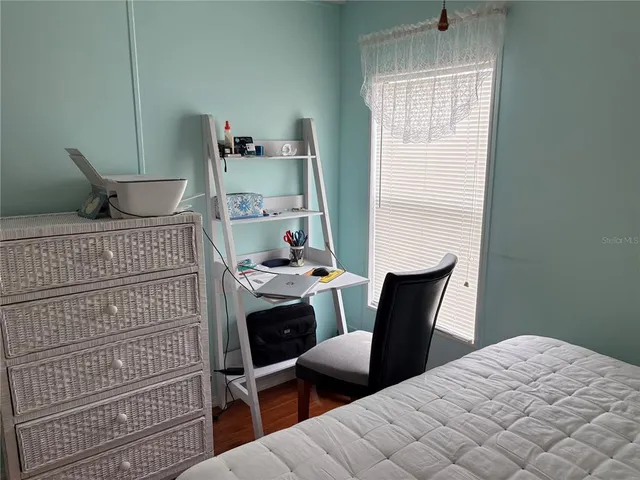 a bedroom with a bed and a chair