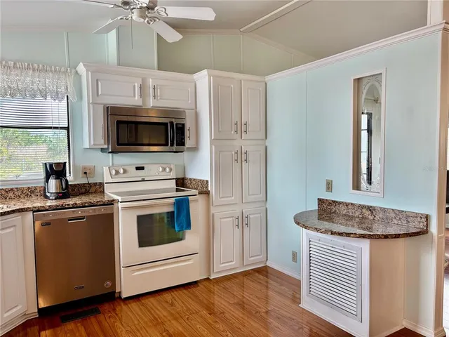 a kitchen with stainless steel appliances granite countertop a stove and a microwave