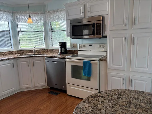 a kitchen with a stove and a microwave