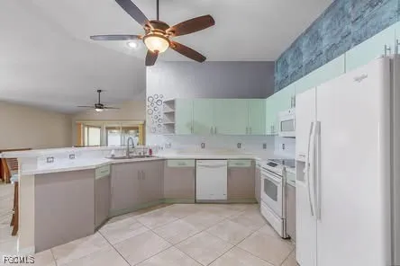 a kitchen with white cabinets and white appliances
