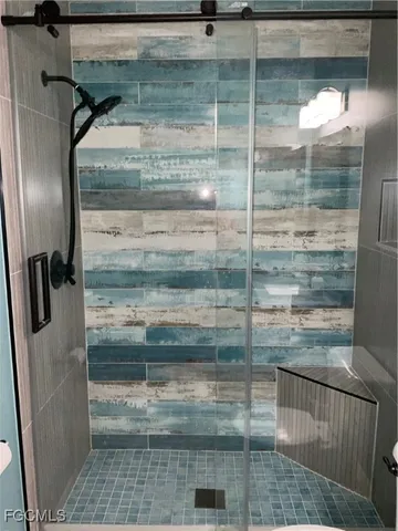 a bathroom with a glass door shower