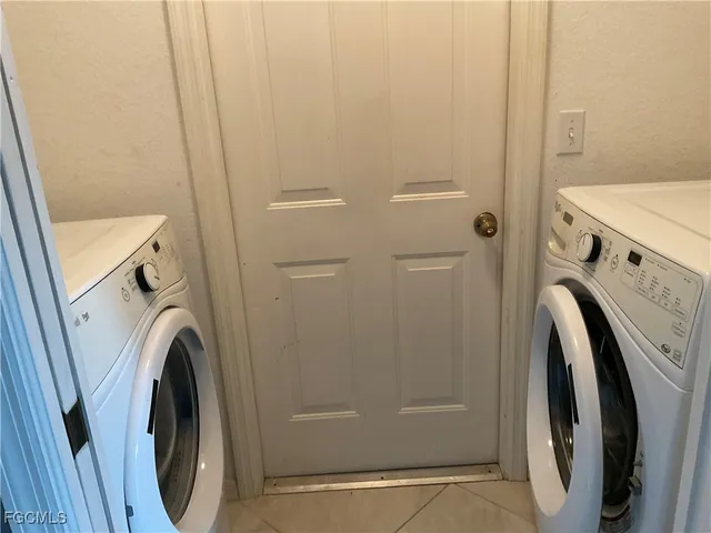 a view of a storage and utility room with washer and dryer