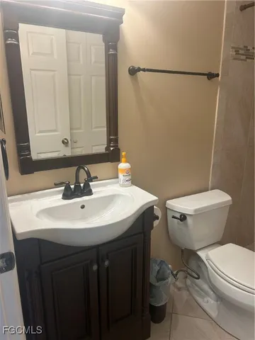 a bathroom with a sink a toilet and a mirror
