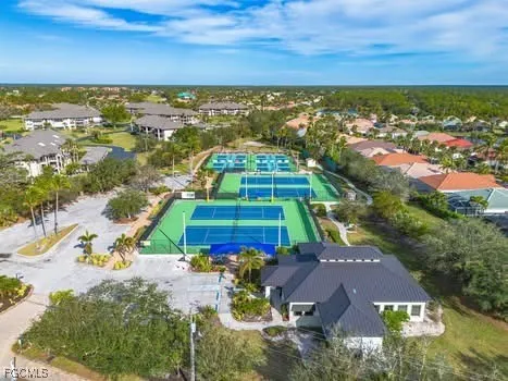 an aerial view of residential houses with outdoor space and ocean view