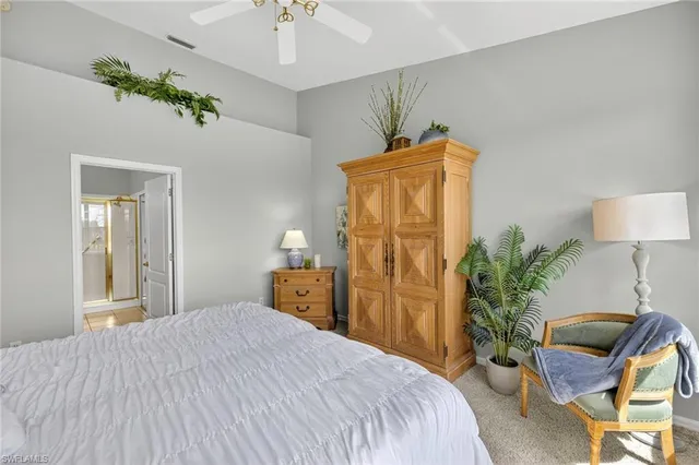 a bedroom with a bed and a potted plant