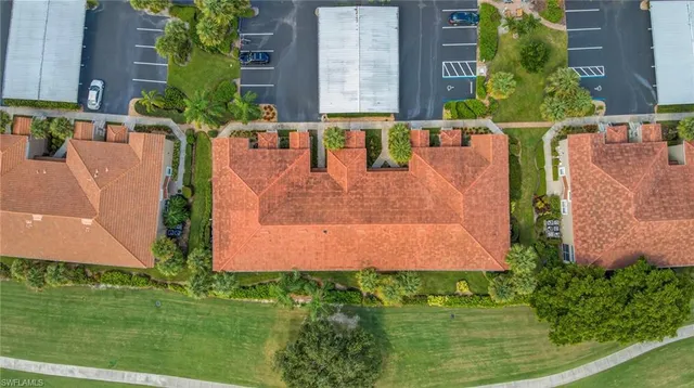 an aerial view of multiple houses with a yard
