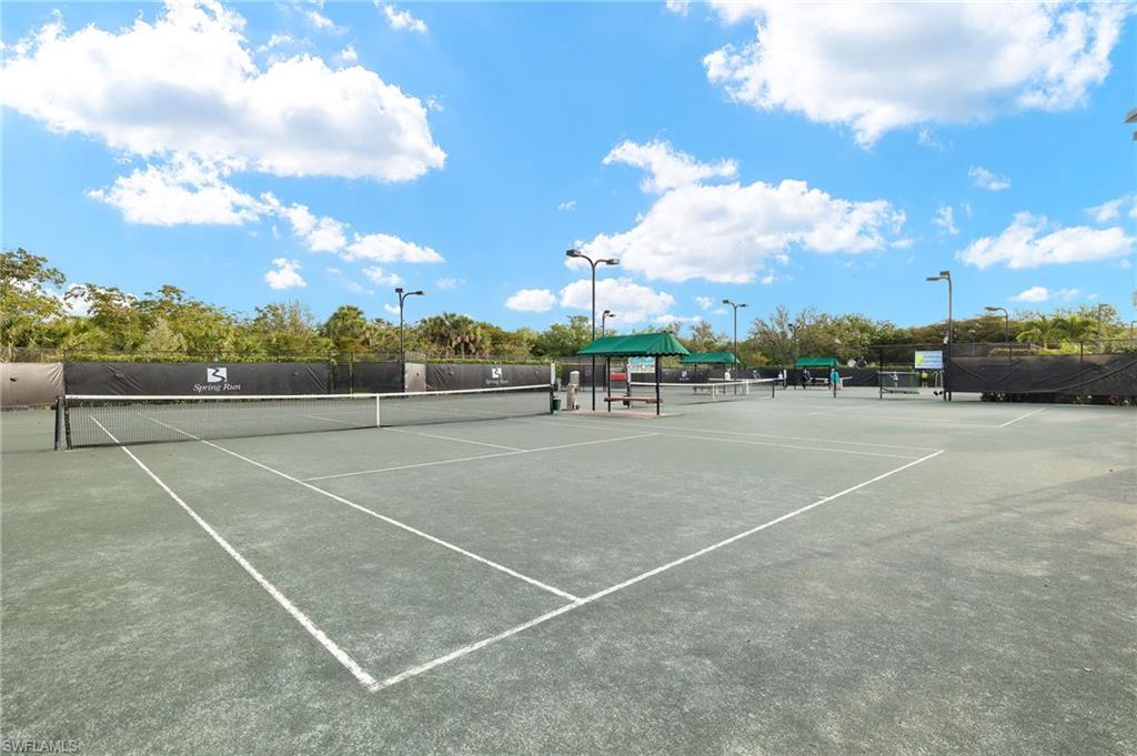 9020 Spring Run Boulevard, Unit 602 Estero, FL 34135 - Photo 44 of 47 Har-Tru tennis courts with lighitng