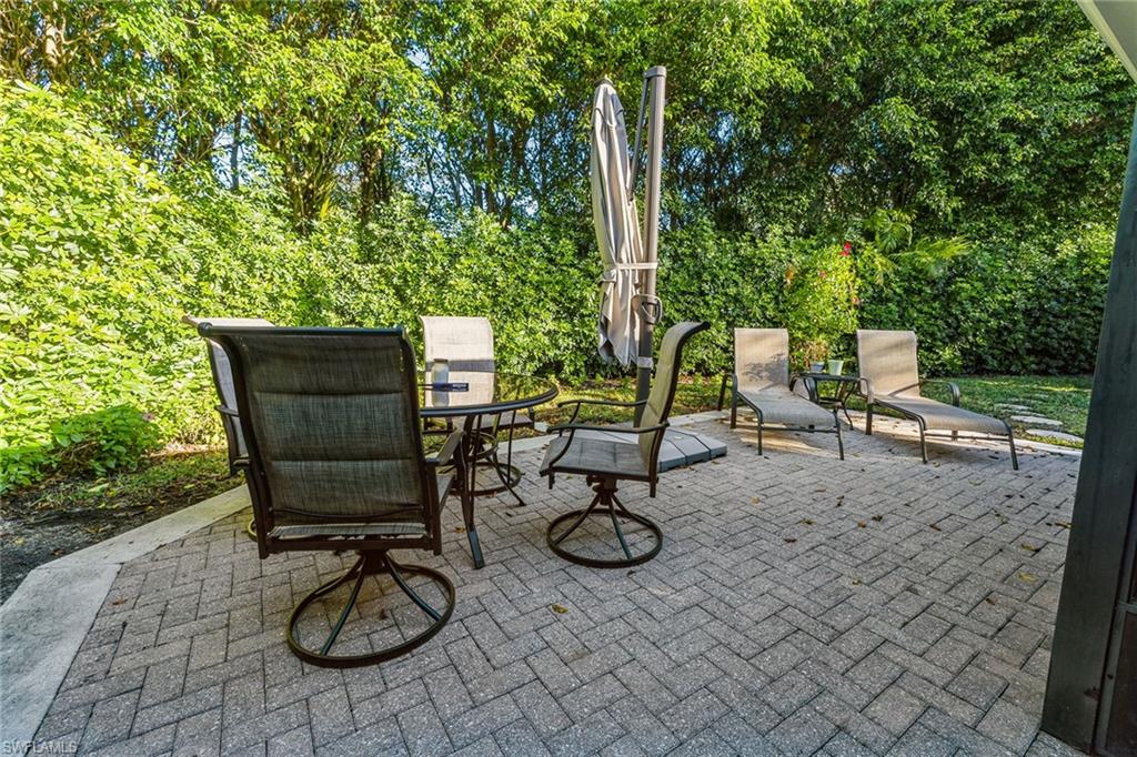 6652 Trident Way, Unit J1 Naples, FL 34108 - Photo 13 of 20 a view of a chairs and table in patio
