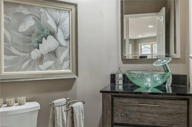 a view of bathroom with a sink and mirror