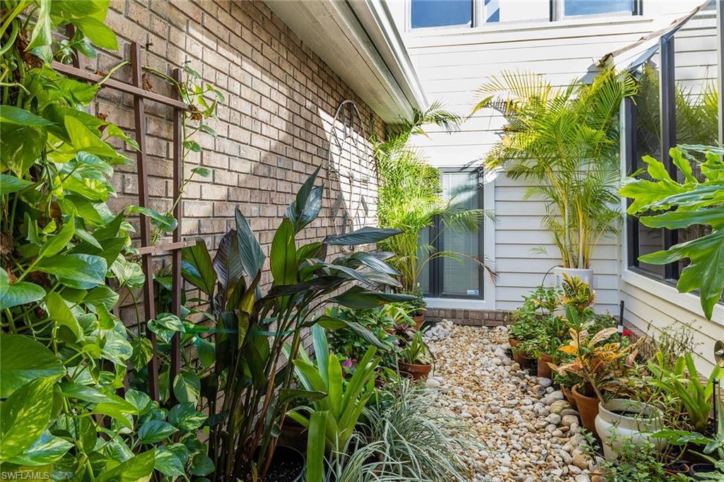 6652 Trident Way, Unit J1 Naples, FL 34108 - Photo 14 of 20 a plant that is in front of a house