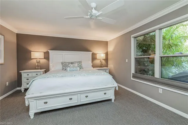 a spacious bedroom with a bed and a large window with outer view