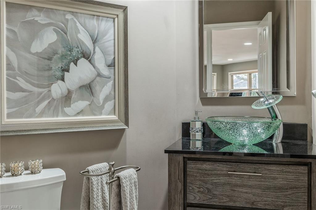 6652 Trident Way, Unit J1 Naples, FL 34108 - Photo 15 of 20 a view of bathroom with a sink and mirror