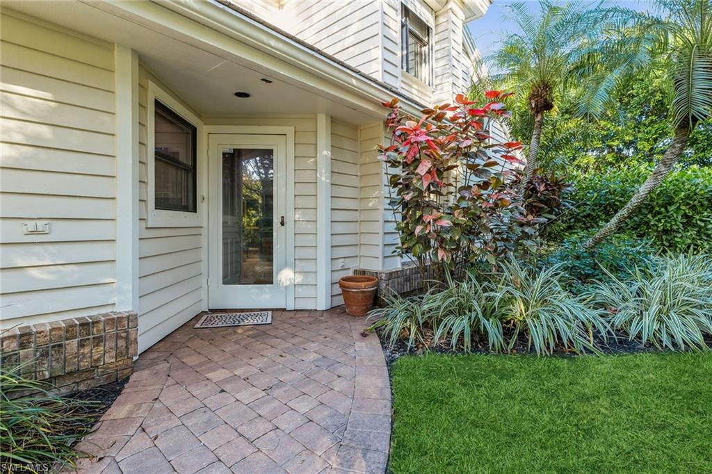 6652 Trident Way, Unit J1 Naples, FL 34108 - Photo 20 of 20 a front view of a house with garden