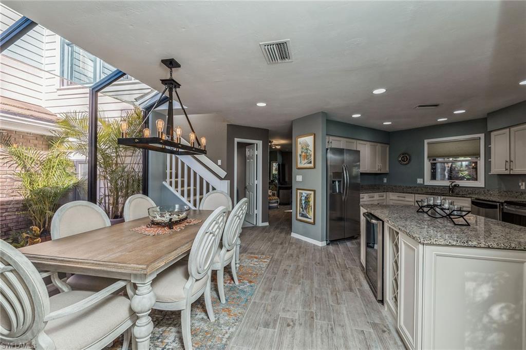 6652 Trident Way, Unit J1 Naples, FL 34108 - Photo 4 of 20 a dining room with furniture and wooden floor