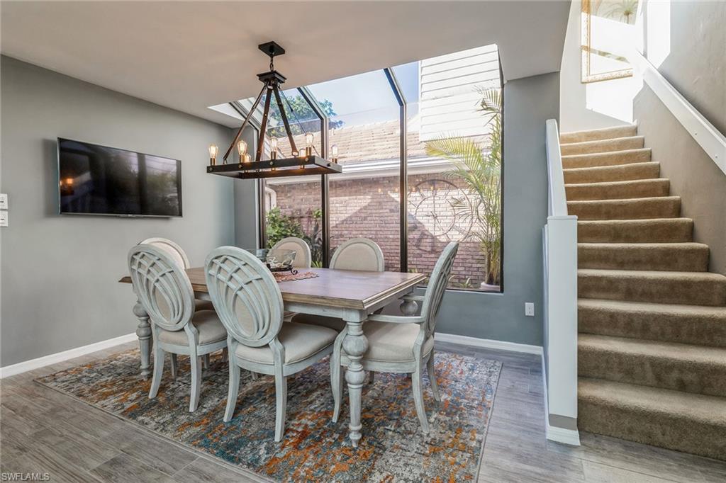 6652 Trident Way, Unit J1 Naples, FL 34108 - Photo 7 of 20 a view of a dining room with furniture window and wooden floor