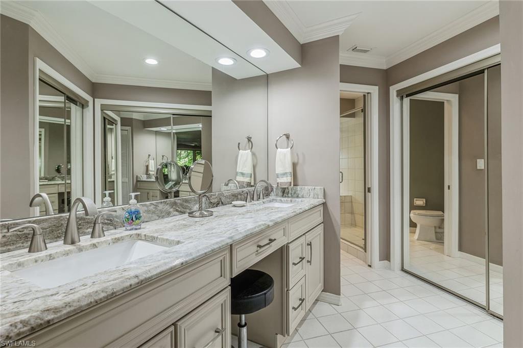 6652 Trident Way, Unit J1 Naples, FL 34108 - Photo 9 of 20 a bathroom with a granite countertop sink and a mirror