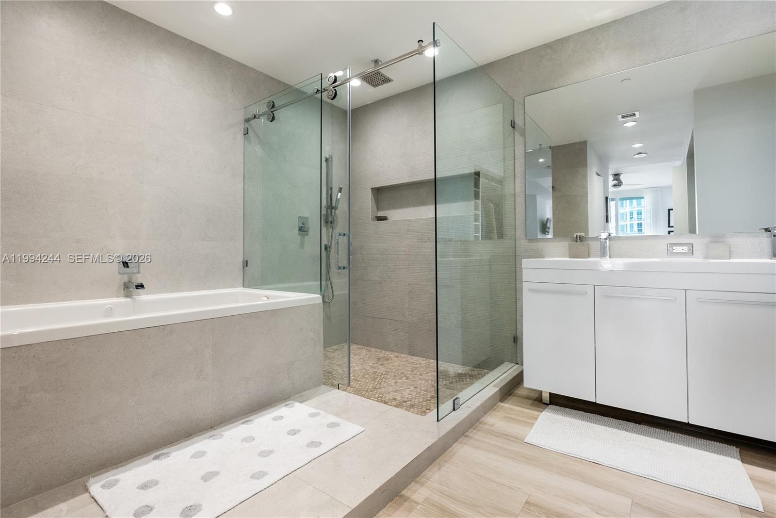 901 Brickell Key Boulevard, Unit 305 Miami, FL 33131 - Photo 14 of 31 a bathroom with a bathtub and a sink