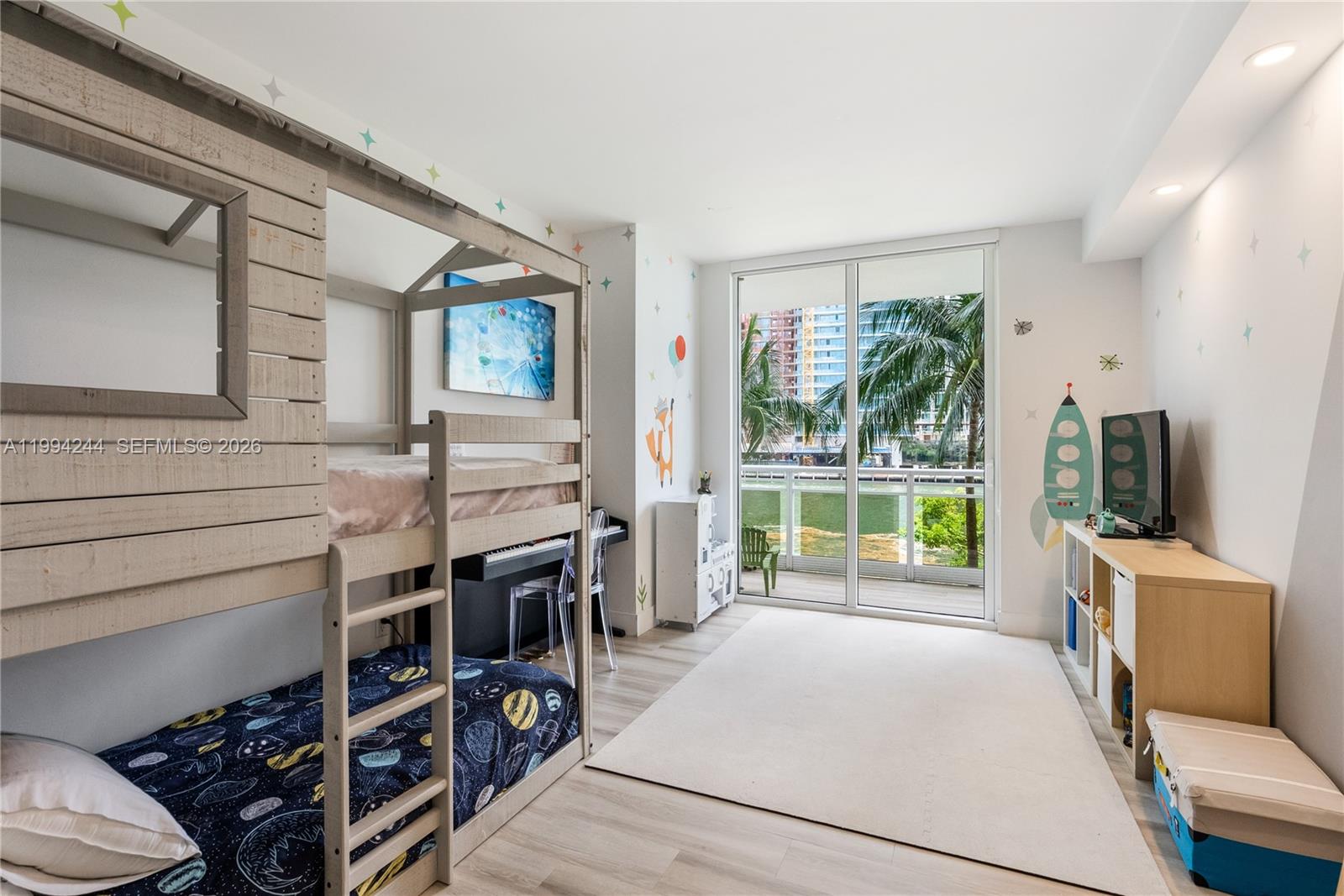 901 Brickell Key Boulevard, Unit 305 Miami, FL 33131 - Photo 17 of 31 a bedroom with furniture and a flat screen tv