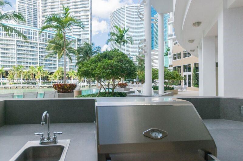 901 Brickell Key Boulevard, Unit 305 Miami, FL 33131 - Photo 31 of 31 a table with a potted plant on it