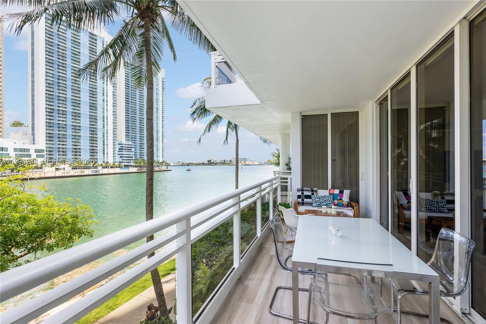 901 Brickell Key Boulevard, Unit 305 Miami, FL 33131 - Photo 7 of 31 a balcony with table and chairs