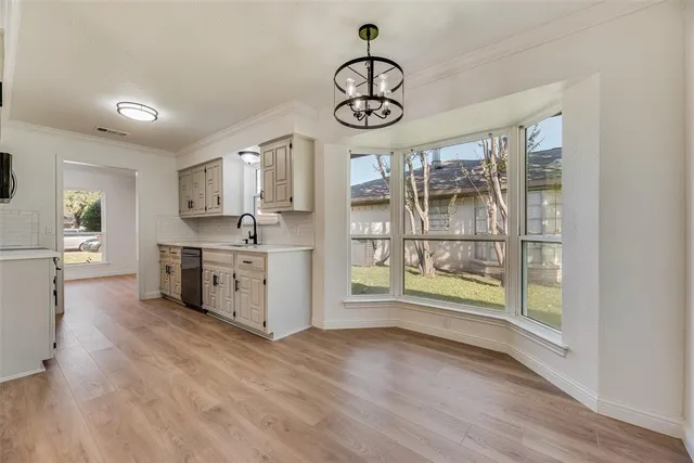a view of a kitchen with fridge and wooden floor