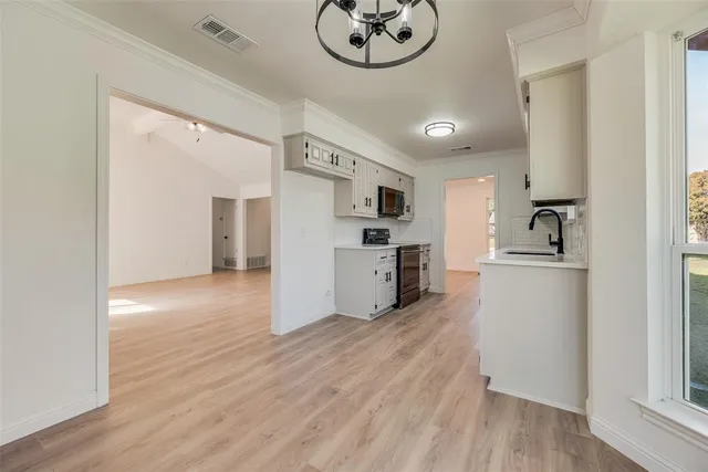 a kitchen with a refrigerator and a stove