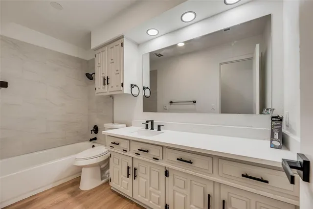 a bathroom with a sink a toilet and a bathtub